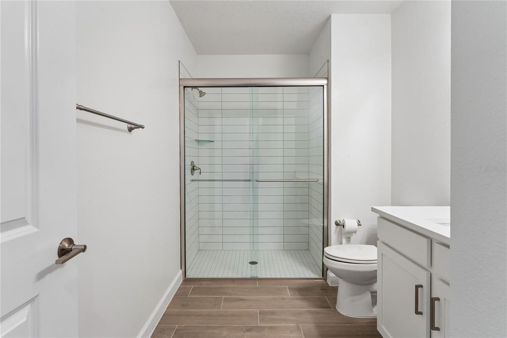 6692 Homebound Way New Port Richey, FL 34653 - Photo 32 of 47 a bathroom with a toilet and shower