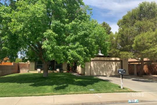 217 Rancho Street Ridgecrest, CA 93555 - Photo 1 of 25 a front view of a house with a yard