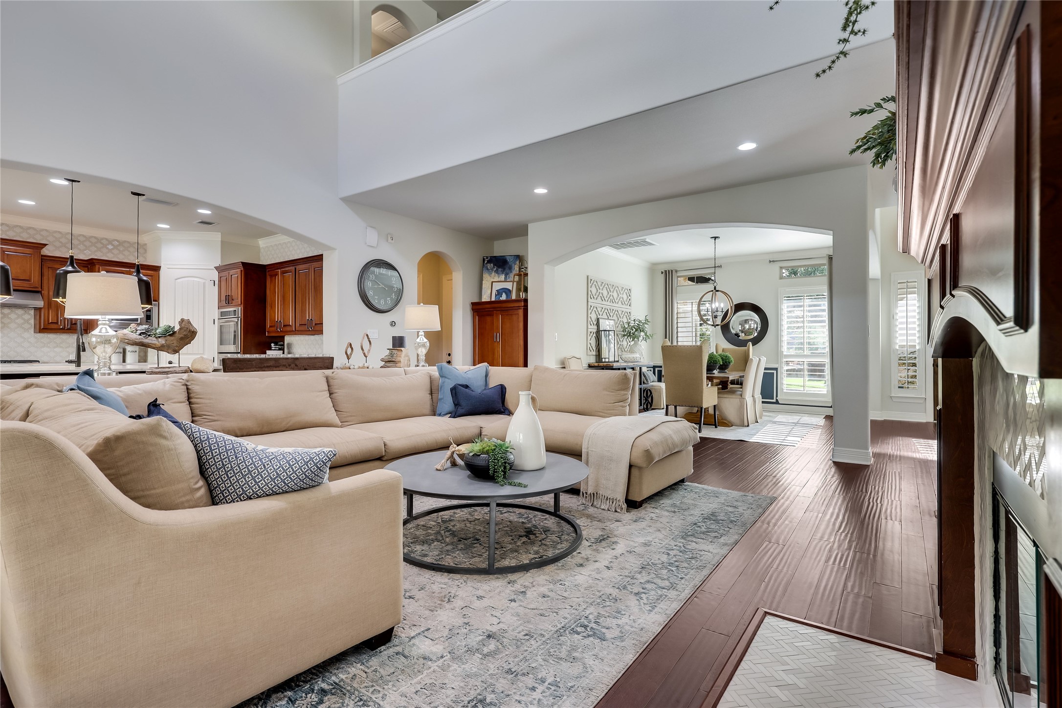 401 Bluff View Road Cedar Park, TX 78613 - Photo 26 of 40 A grand, naturally illuminated living area showcases a soaring ceiling and rich wood flooring.