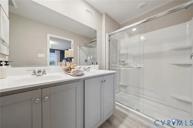 a bathroom with a sink a mirror and a shower