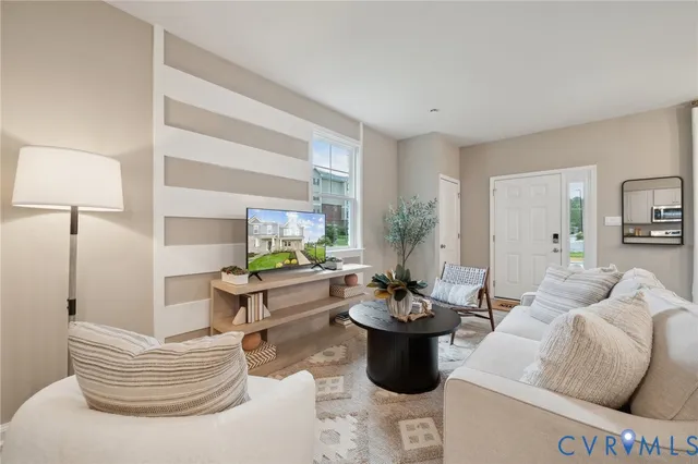 a living room with furniture and a potted plant