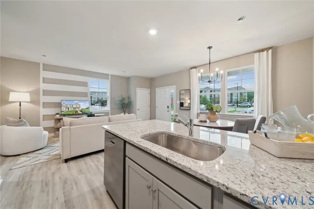 a kitchen with a sink and living room