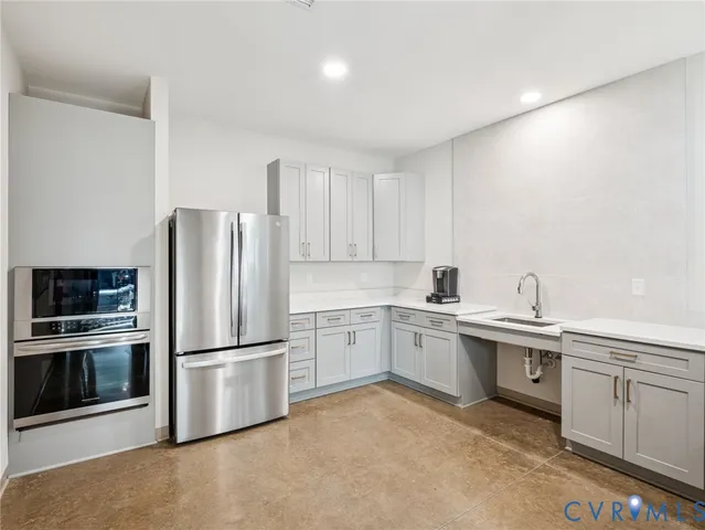 a living room with furniture and a view of kitchen