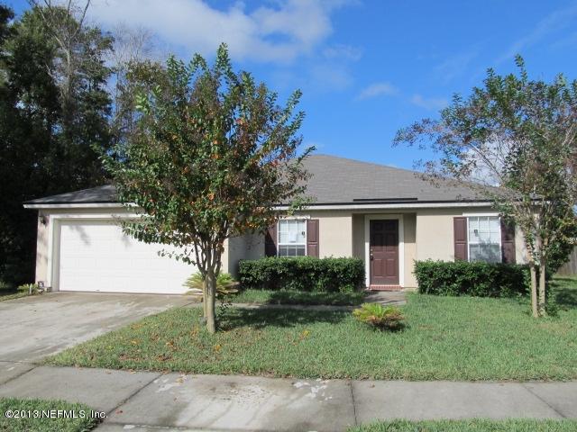 3269 Garden Brook Road Jacksonville, FL 32208 - Photo 1 of 8 a front view of a house with a garden