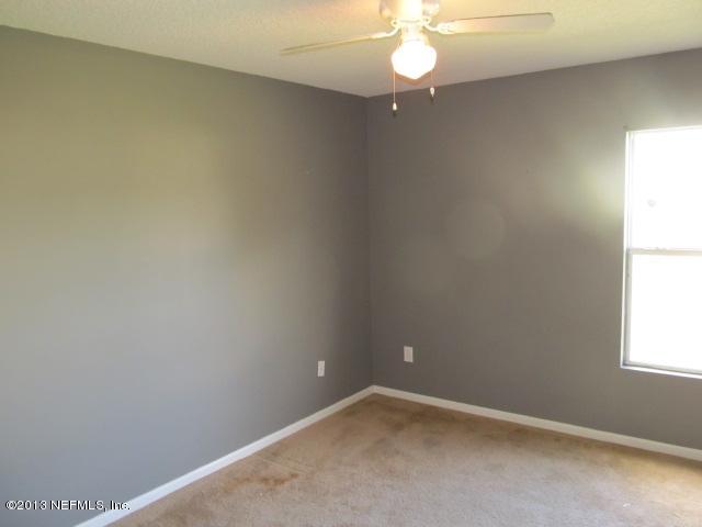 3269 Garden Brook Road Jacksonville, FL 32208 - Photo 2 of 8 an empty room with a window