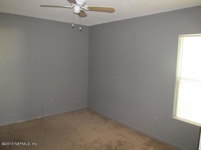 3269 Garden Brook Road Jacksonville, FL 32208 - Photo 3 of 8 an empty room with a window
