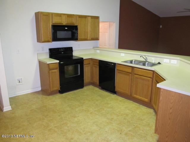 3269 Garden Brook Road Jacksonville, FL 32208 - Photo 6 of 8 a kitchen with a stove top oven and sink