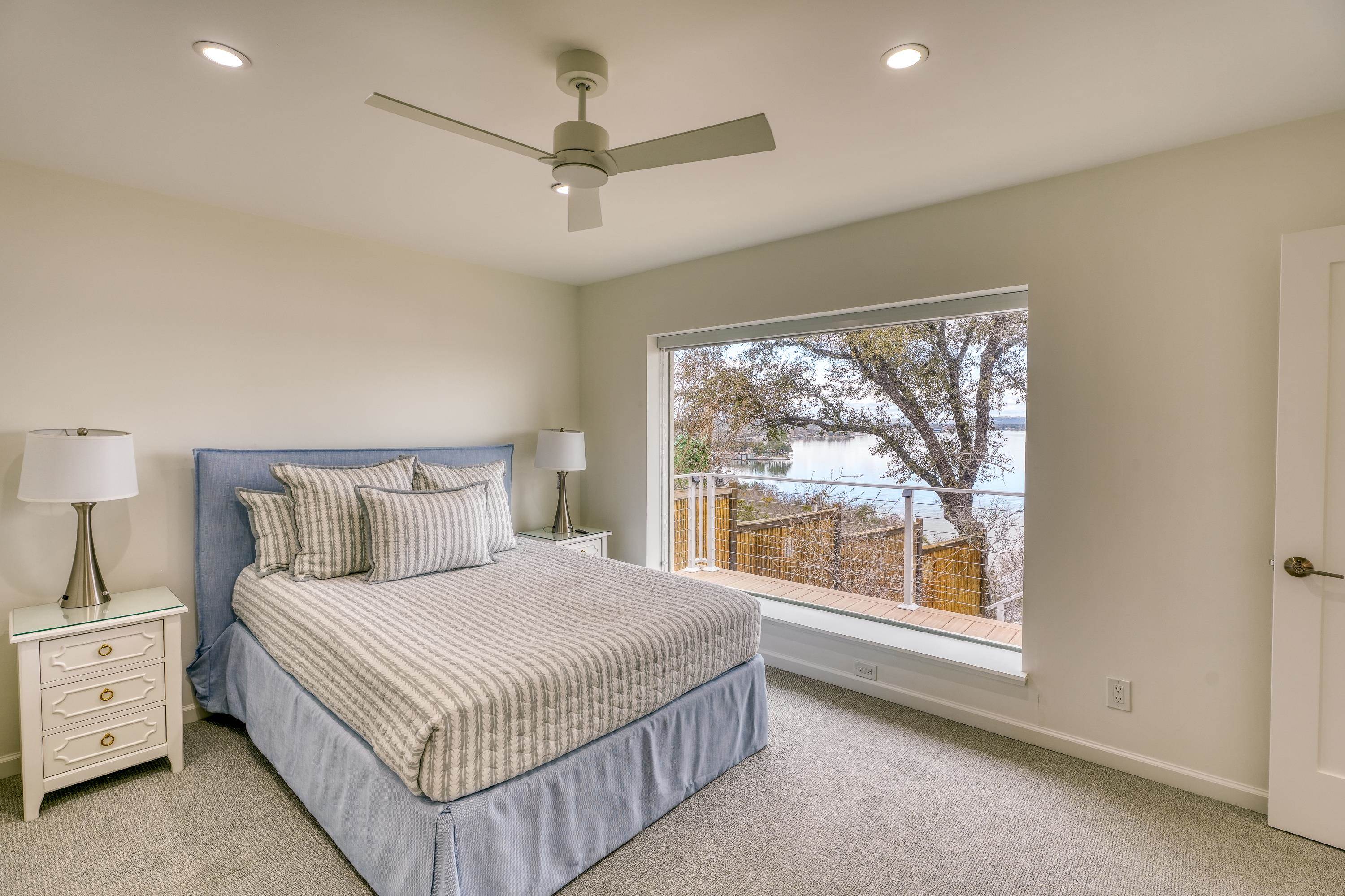 204 Blue Ridge Trail Horseshoe Bay, TX 78657 - Photo 17 of 28 a bedroom with a large bed and a large window