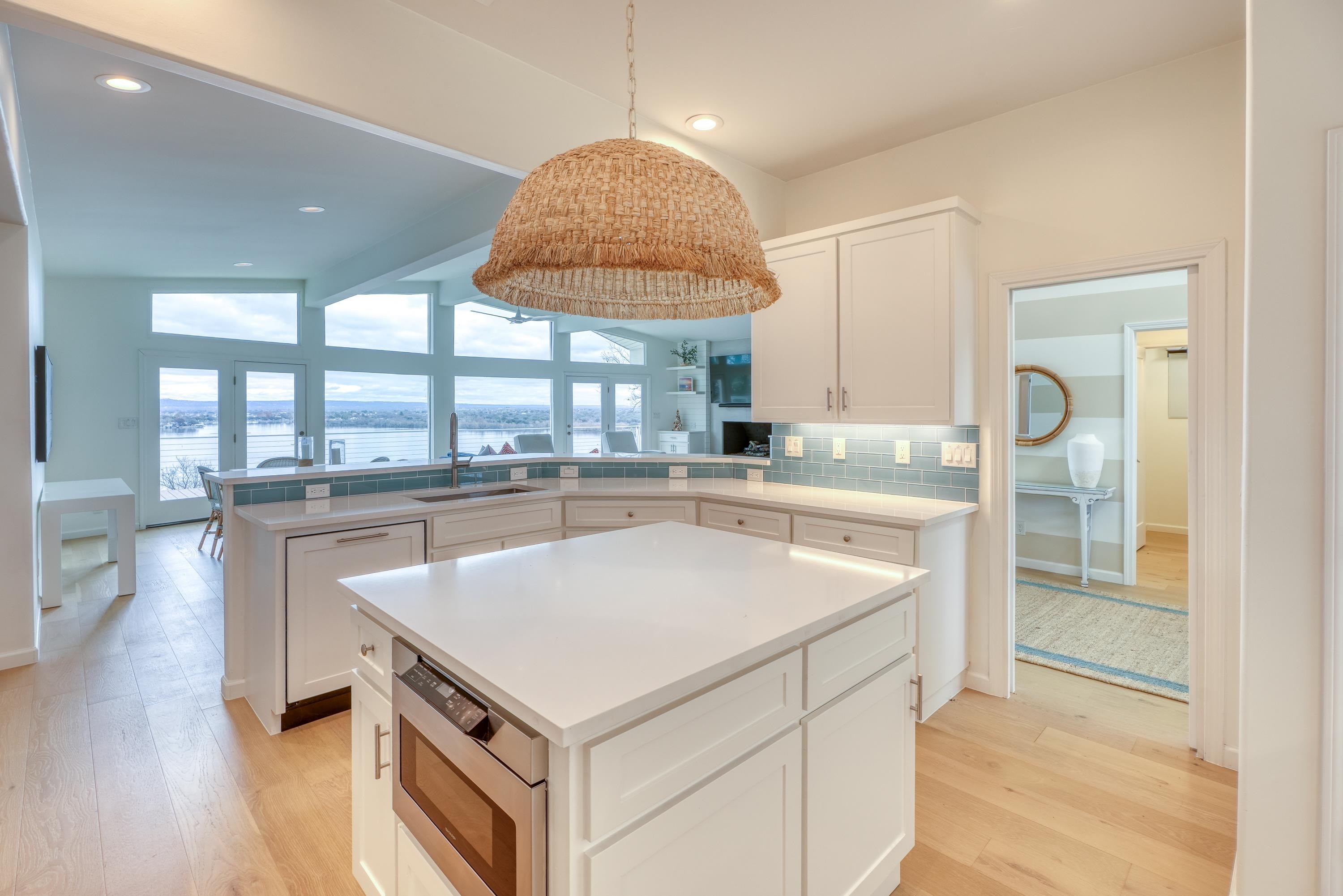 204 Blue Ridge Trail Horseshoe Bay, TX 78657 - Photo 7 of 28 a kitchen with a sink cabinets and wooden floor