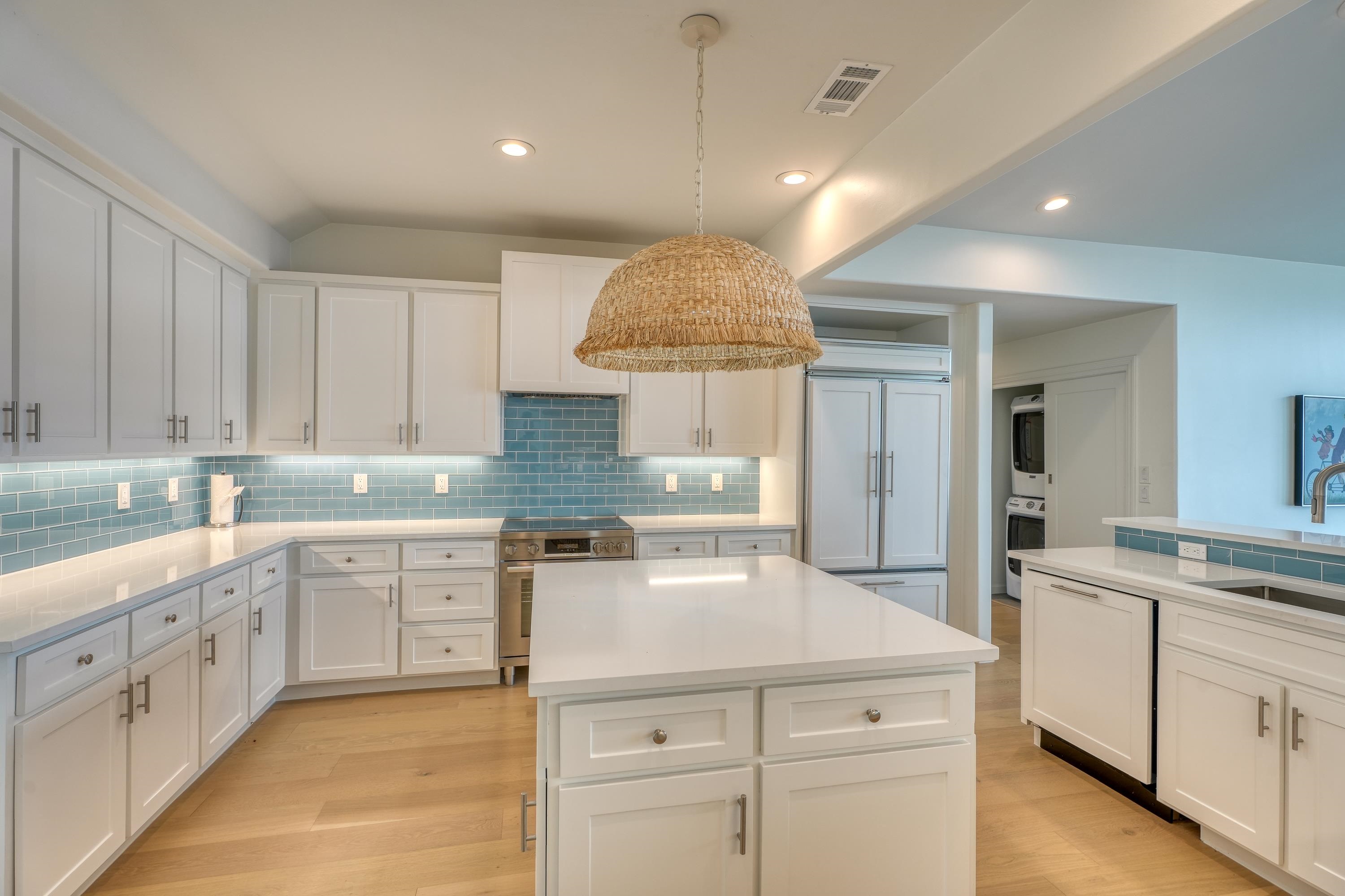 204 Blue Ridge Trail Horseshoe Bay, TX 78657 - Photo 8 of 28 a kitchen with a white cabinets and chandelier