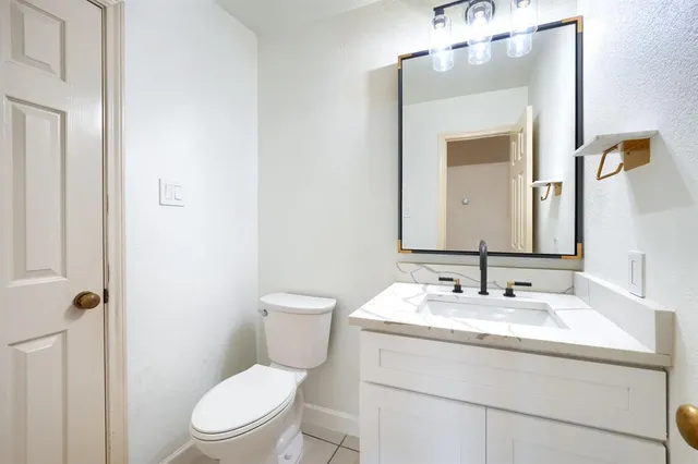 a view of a bedroom with a ceiling fan and window
