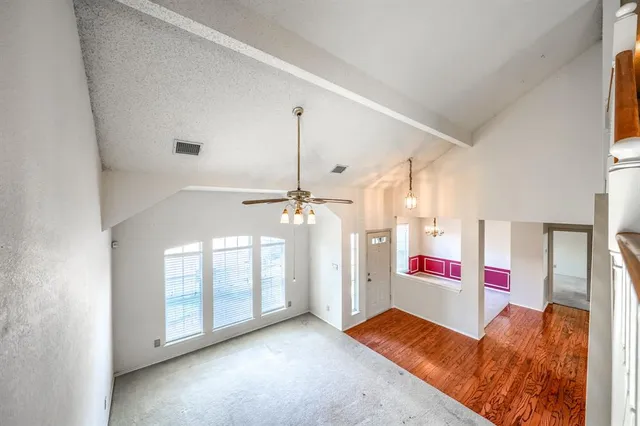 a bedroom with a bed tv and a window