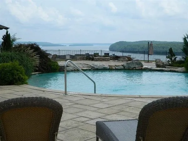 a view of outdoor space with swimming pool and lake view