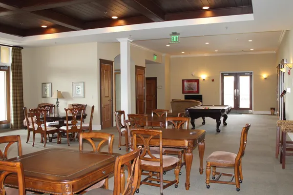 a dining hall with lots of tables and chairs