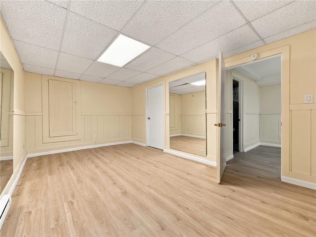 90 Gun Club Road Palmerton, PA 18071 - Photo 53 of 58 A versatile lower-level space features warm wood-look flooring and wainscot paneled walls.