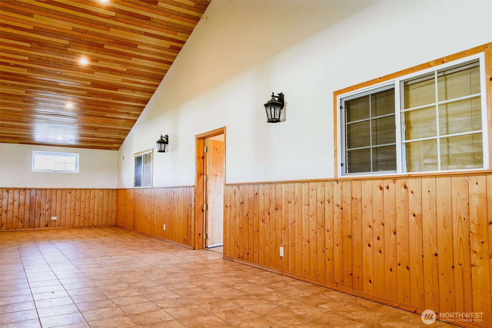 2034 North Pine Creek Road Tonasket, WA 98855 - Photo 10 of 38 a view of an empty room with wooden walls