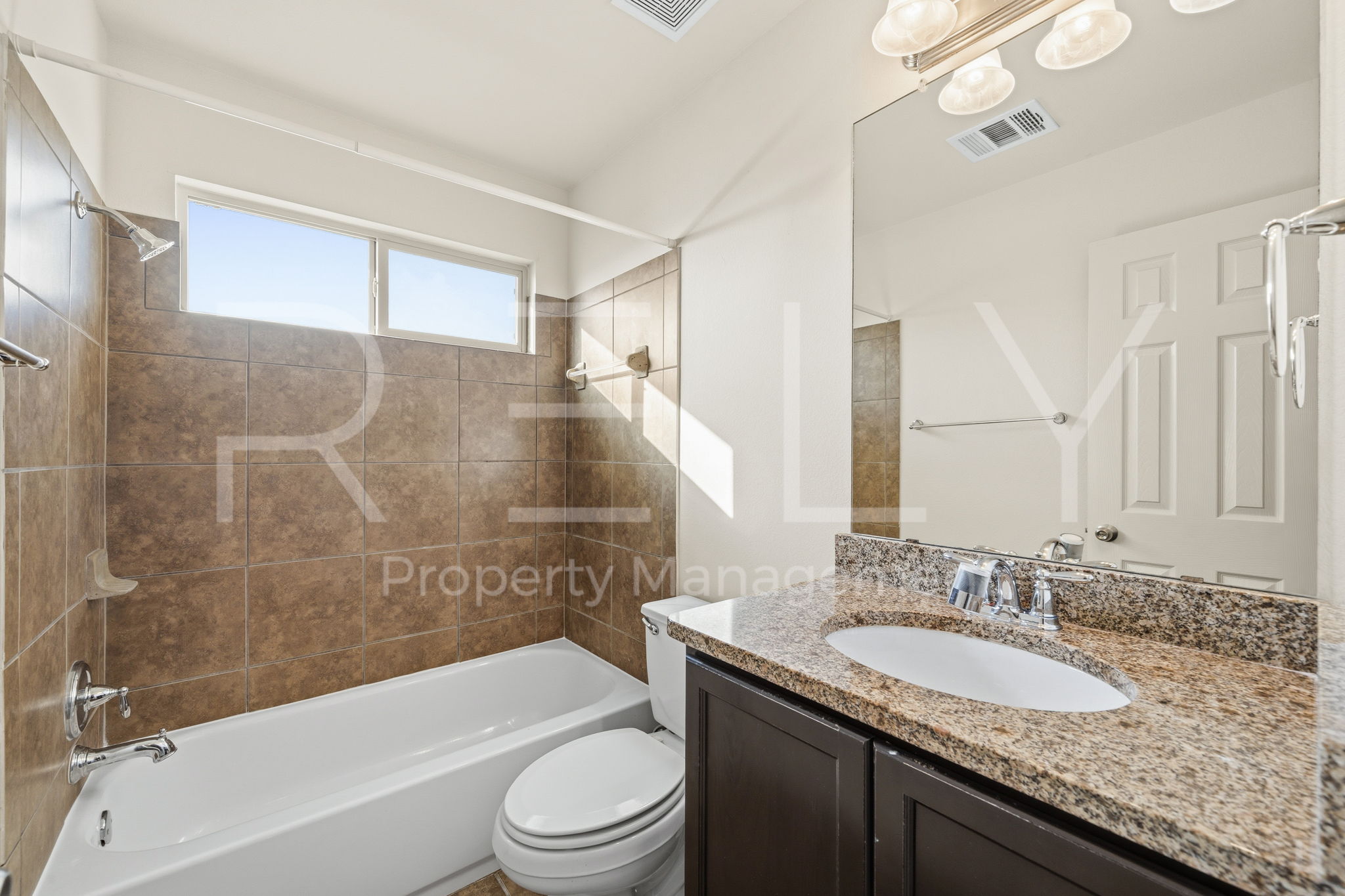 1405 Sunny Meadows Loop Georgetown, TX 78626 - Photo 27 of 40 A well-appointed bathroom features a bathtub with shower and a vanity with a granite countertop.