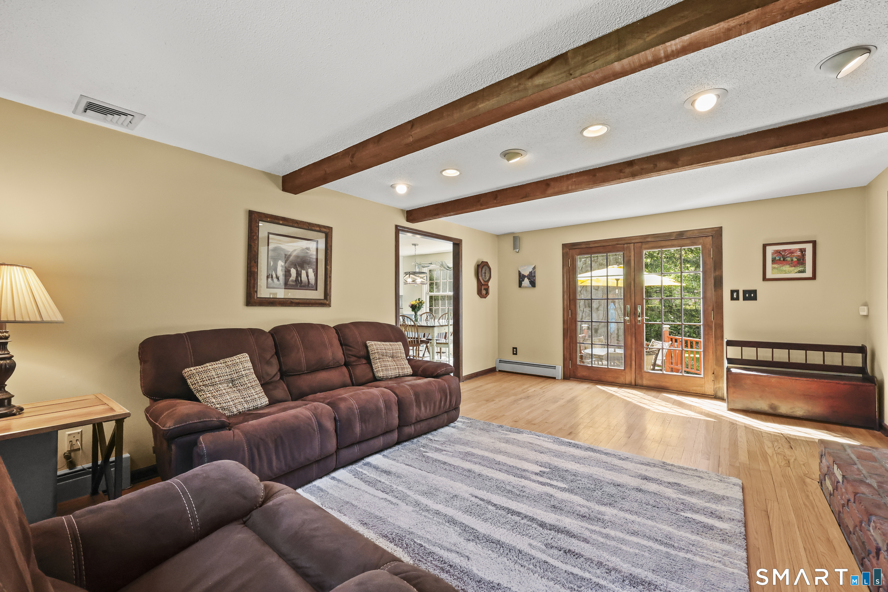 17 Briar Hill Road Avon, CT 06001 - Photo 5 of 38 Warm and inviting with soothing colors. This family room features a LOPI flush mount fireplace insert which can warm the downstairs on chilly night. Anderson doors can open on both sides to allow easy access to the deck.