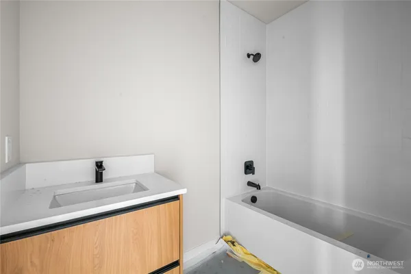 a bathroom with a bathtub and shower