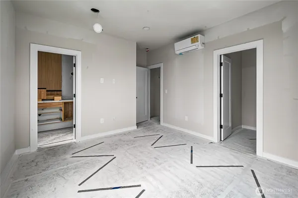 an empty room with closet and windows