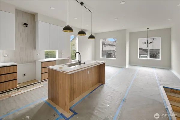 a kitchen with a stove a sink a window and a refrigerator