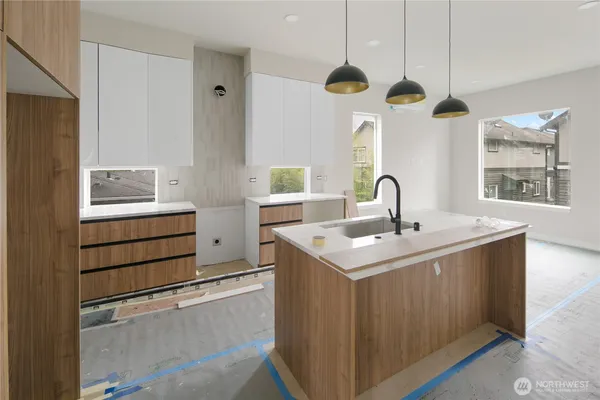 a kitchen with a sink dishwasher a stove and a refrigerator with wooden floor