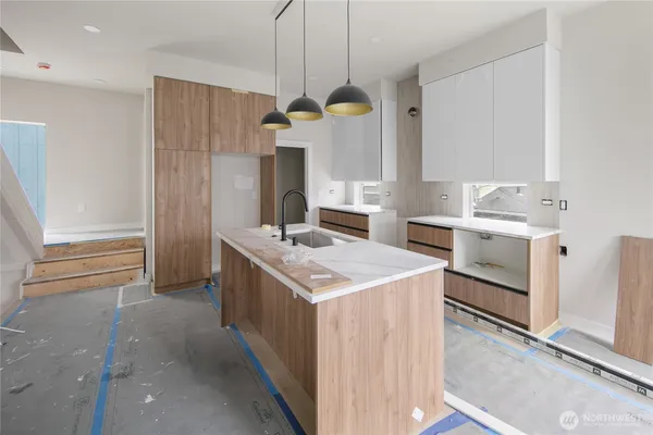 a kitchen with a stove and a refrigerator
