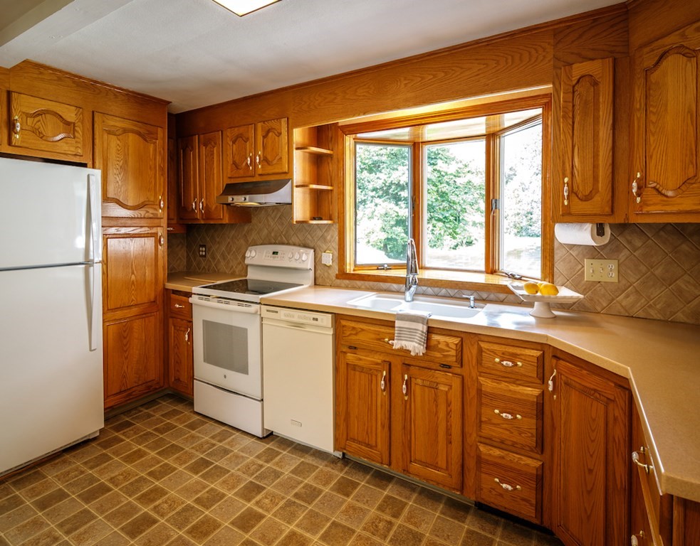 182 Wayside Inn Road Sudbury, MA 01776 - Photo 11 of 42 a kitchen with sink cabinets and window