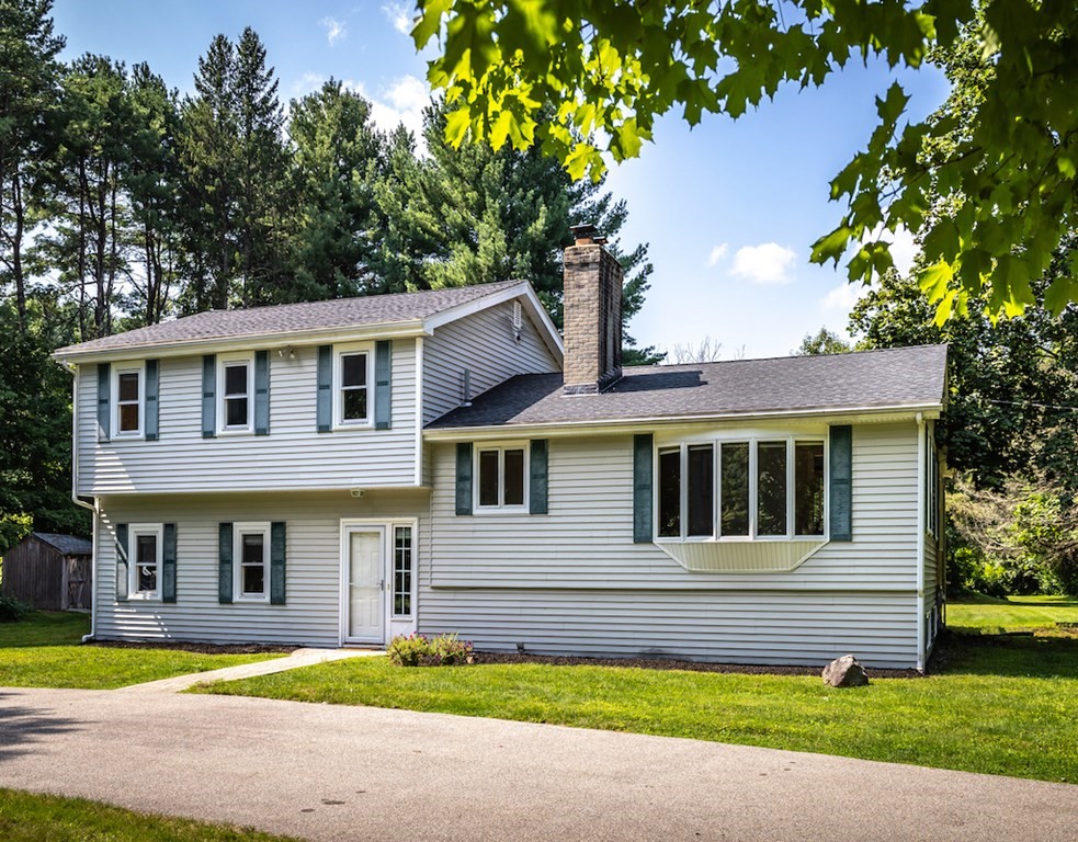 182 Wayside Inn Road Sudbury, MA 01776 - Photo 3 of 42 a front view of a house with a yard and garage