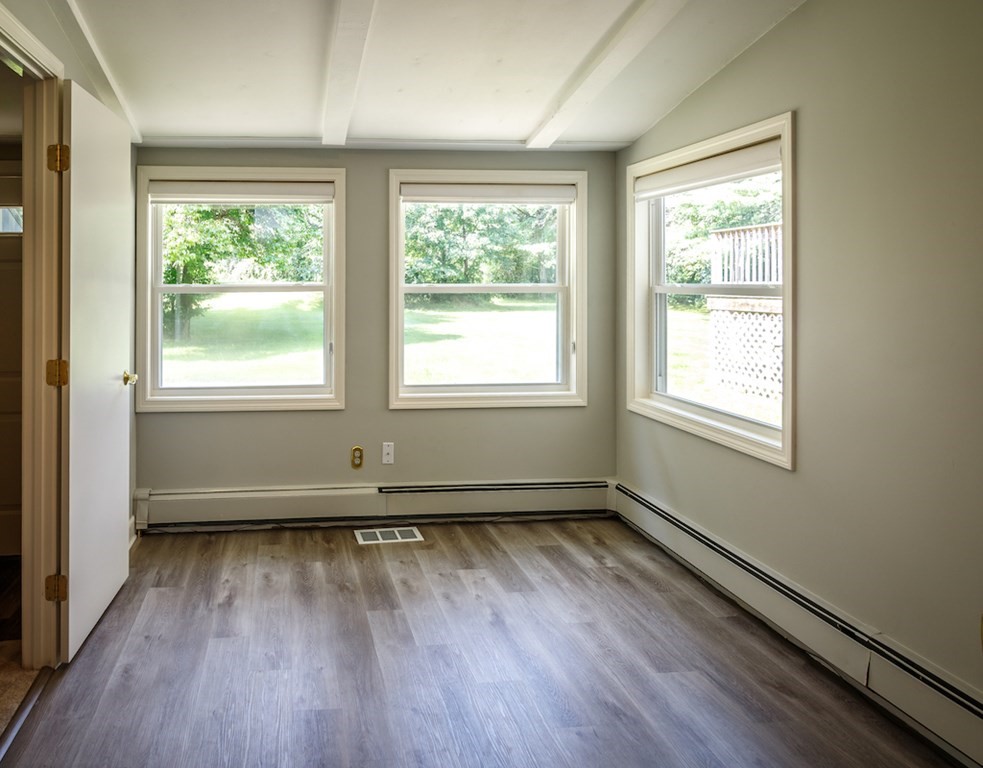 182 Wayside Inn Road Sudbury, MA 01776 - Photo 32 of 42 an empty room with wooden floor and windows
