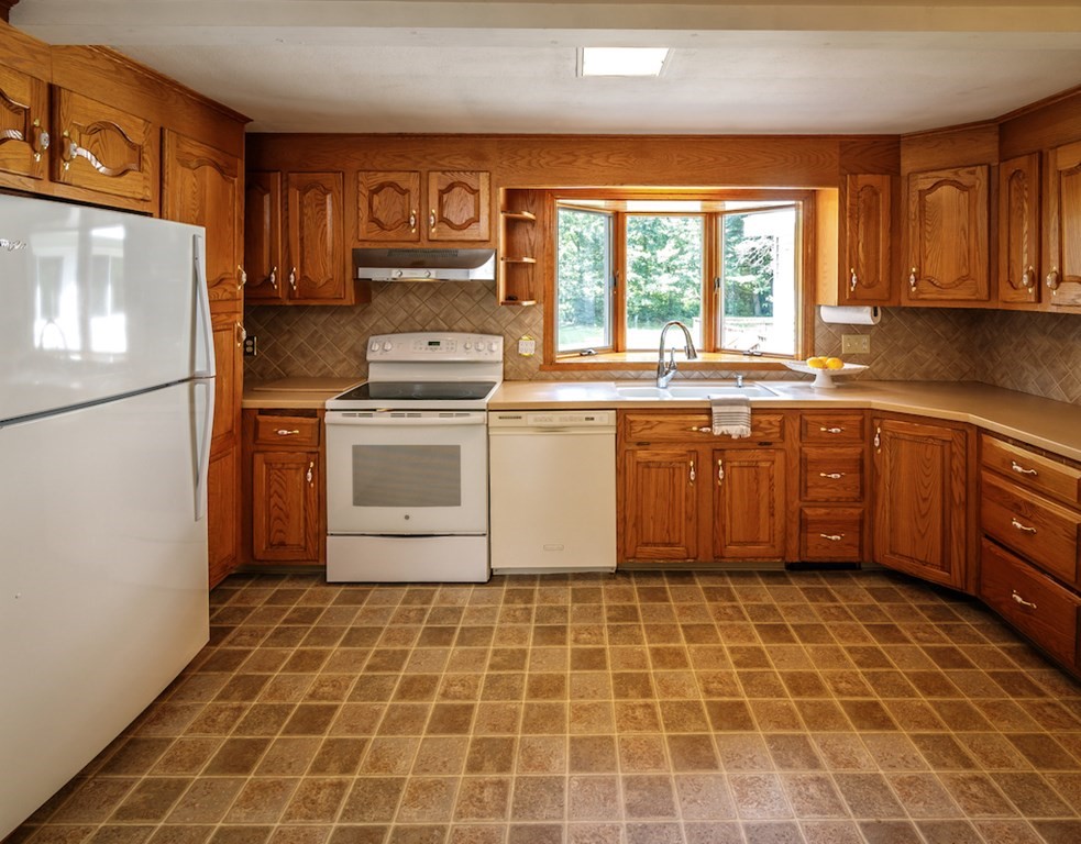 182 Wayside Inn Road Sudbury, MA 01776 - Photo 7 of 42 a kitchen with a stove a sink and a refrigerator