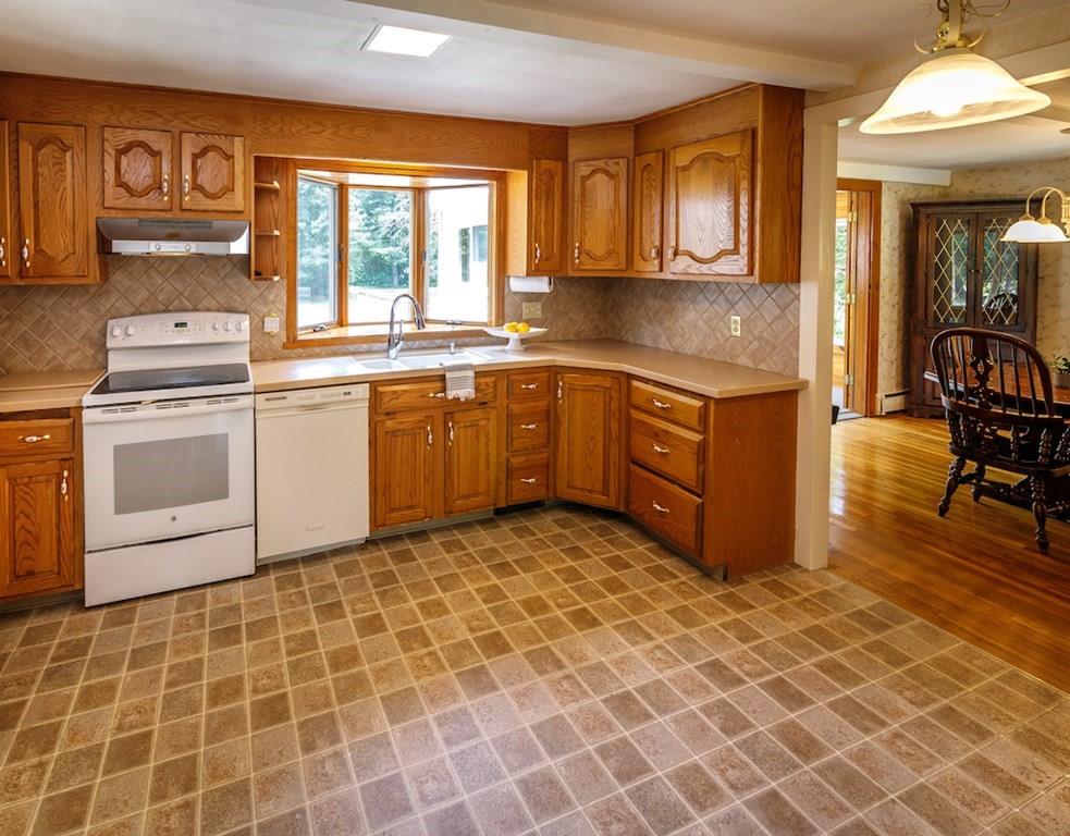 182 Wayside Inn Road Sudbury, MA 01776 - Photo 8 of 42 a kitchen with stainless steel appliances granite countertop a stove a sink and a microwave