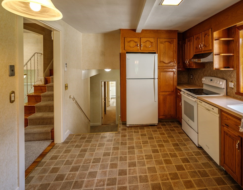 182 Wayside Inn Road Sudbury, MA 01776 - Photo 9 of 42 a kitchen with a sink a refrigerator and cabinets