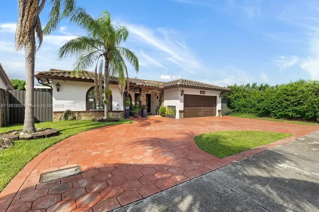 a front view of house with yard and green space