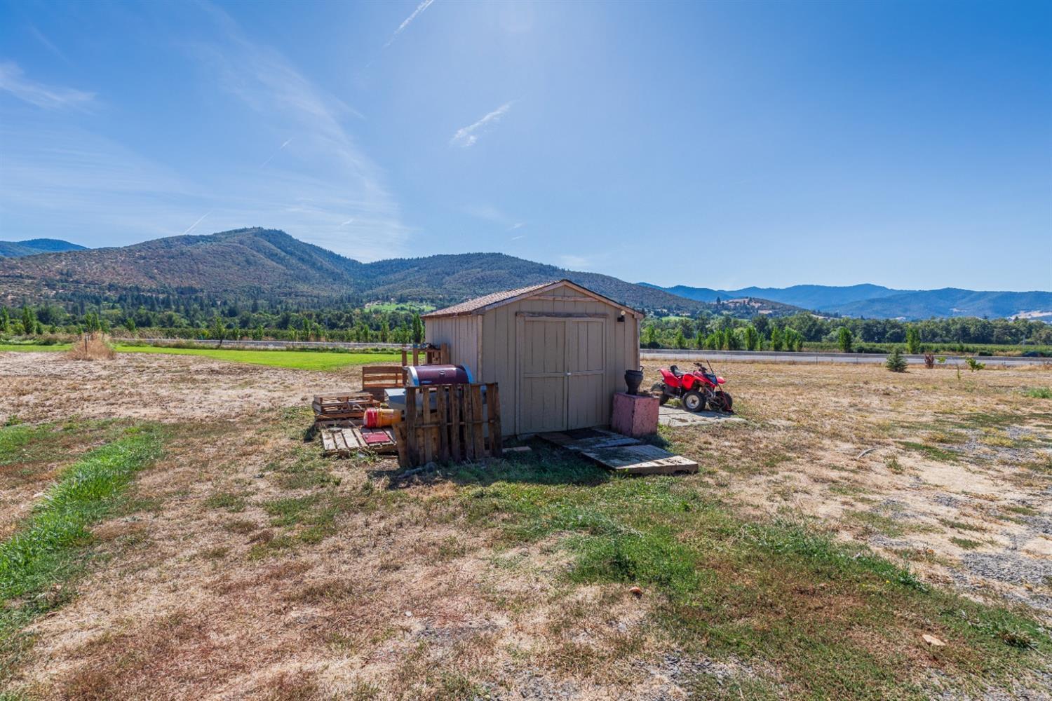 728 West Valley View Road Ashland, OR 97520 - Photo 4 of 32 a view of a lake with a mountain and a big yard