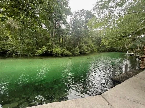 a view of a lake with a yard