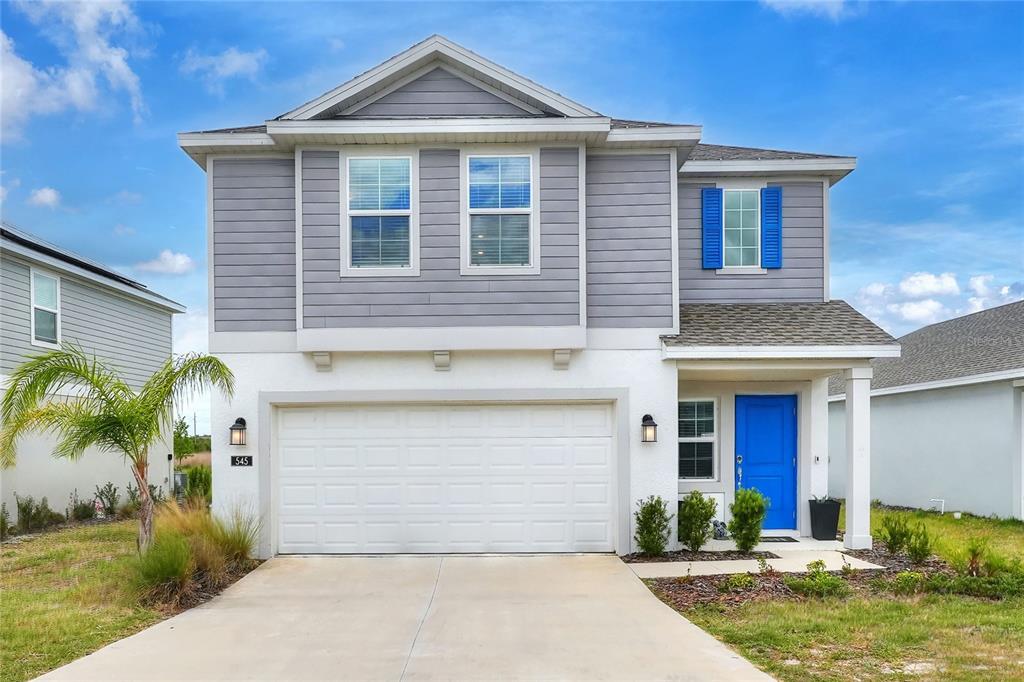 545 Bell Prairie Circle Lake Wales, FL 33859 - Photo 1 of 42 a front view of a house with garden