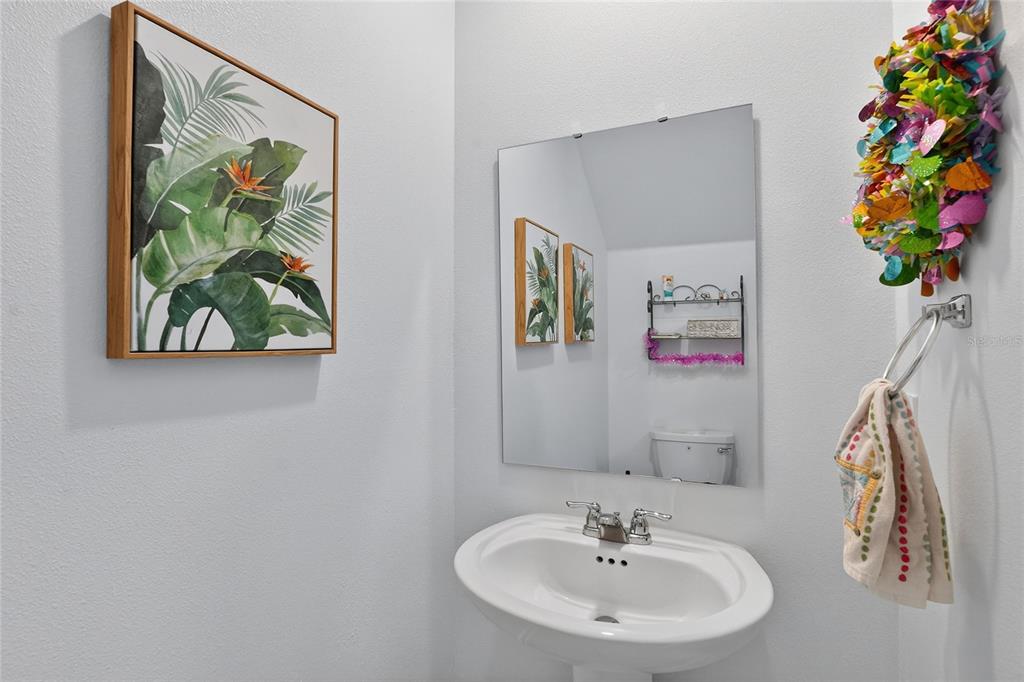 545 Bell Prairie Circle Lake Wales, FL 33859 - Photo 15 of 42 a bathroom with a sink a mirror and painting on the wall