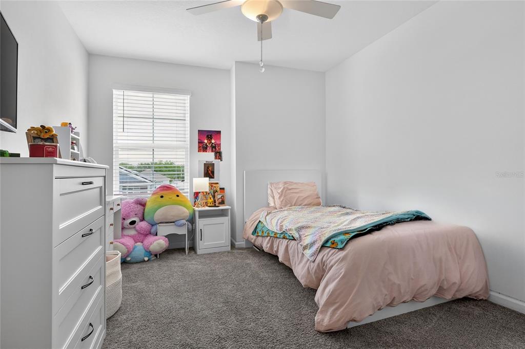 545 Bell Prairie Circle Lake Wales, FL 33859 - Photo 23 of 42 a bedroom with a bed a window and a chandelier