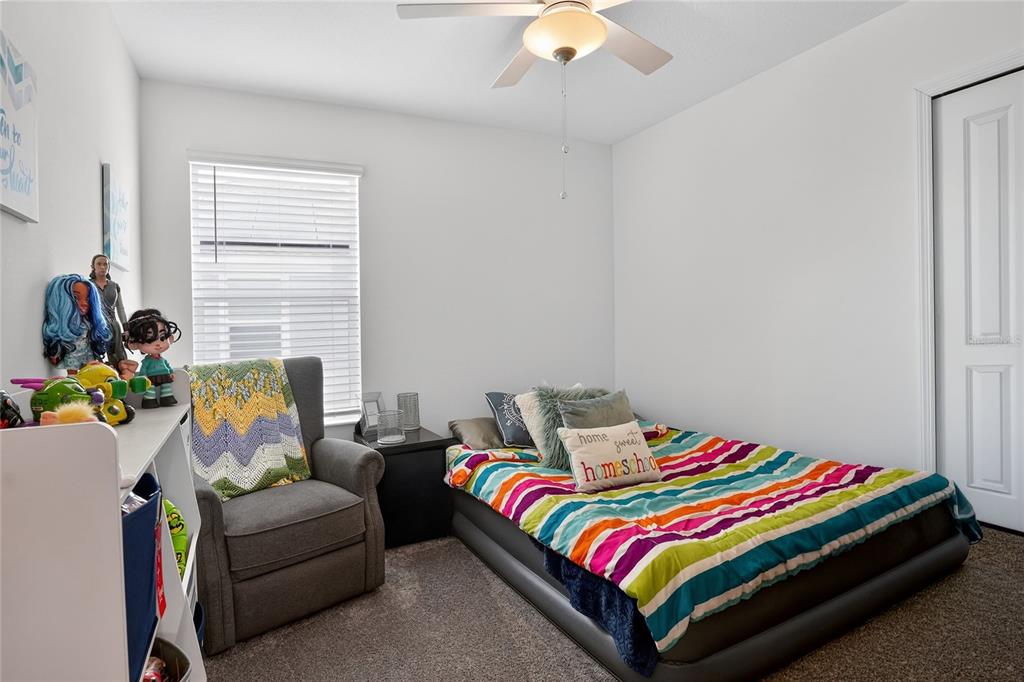 545 Bell Prairie Circle Lake Wales, FL 33859 - Photo 24 of 42 a living room with a bed furniture and a window