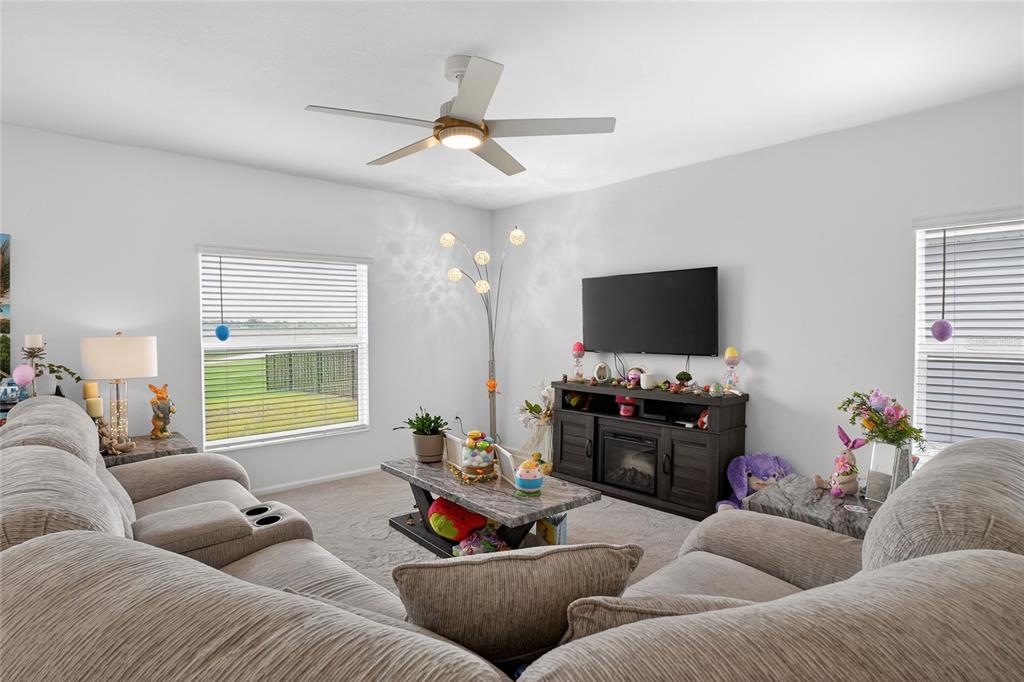 545 Bell Prairie Circle Lake Wales, FL 33859 - Photo 4 of 42 a living room with furniture and a flat screen tv