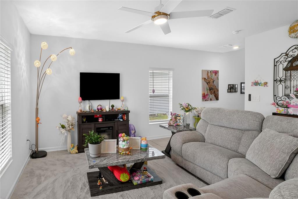 545 Bell Prairie Circle Lake Wales, FL 33859 - Photo 5 of 42 a living room with furniture and a flat screen tv