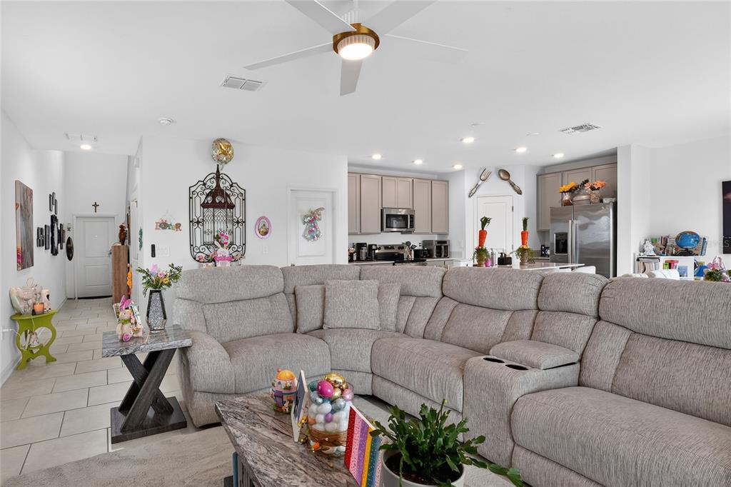 545 Bell Prairie Circle Lake Wales, FL 33859 - Photo 6 of 42 a living room with furniture kitchen view and a chandelier