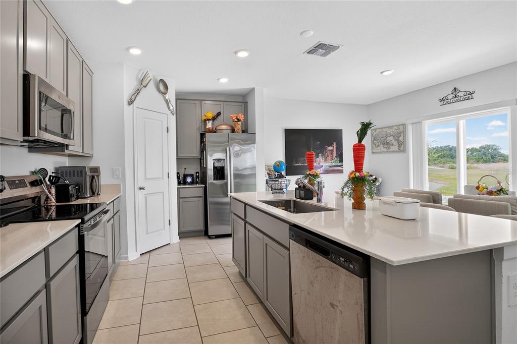 545 Bell Prairie Circle Lake Wales, FL 33859 - Photo 7 of 42 a kitchen with stainless steel appliances a sink counter space cabinets and a window