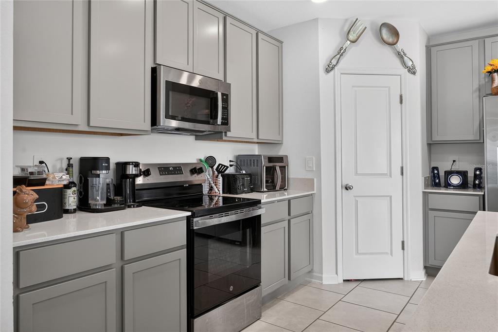 545 Bell Prairie Circle Lake Wales, FL 33859 - Photo 9 of 42 a kitchen with stainless steel appliances granite countertop white cabinets and a stove
