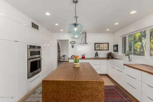 a living room with wooden floor furniture and a window