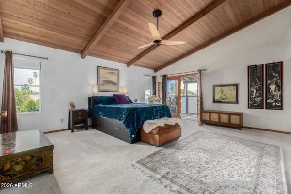 a bedroom with a large bed and a couch