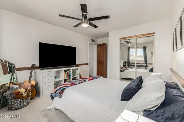 a bedroom with a bed and a desk