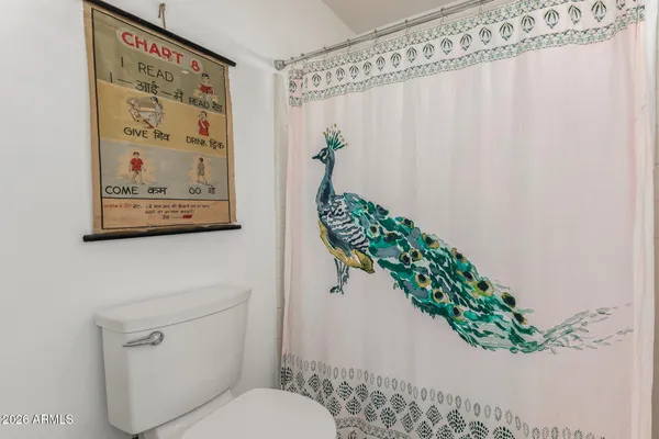 a bedroom with a bed and a flat screen television