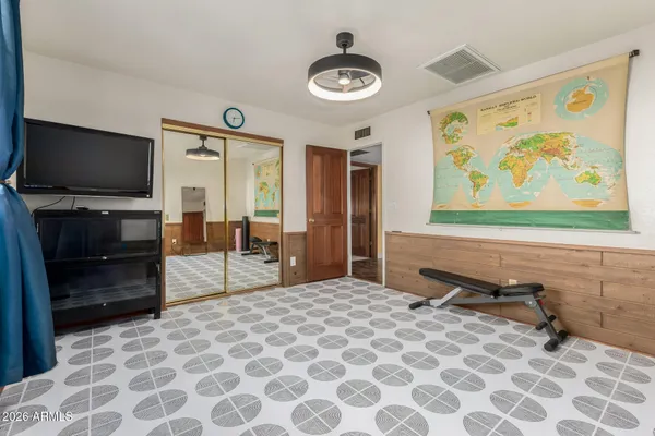 a bedroom with a bed and a chandelier